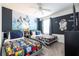Stylish bedroom featuring two beds, Star Wars-themed decor, and a ceiling fan at 780 Drop Shot Dr, Davenport, FL 33896