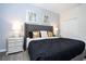 Comfortable bedroom featuring a tufted headboard, decorative pillows, and sleek nightstands at 780 Drop Shot Dr, Davenport, FL 33896