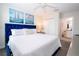 Bright bedroom with a white ceiling fan, nautical decor, and a view into a bathroom at 780 Drop Shot Dr, Davenport, FL 33896