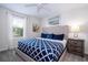 Comfortable bedroom featuring a queen bed, soft natural lighting, and a tranquil view from the window at 780 Drop Shot Dr, Davenport, FL 33896
