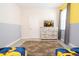 Minion themed bedroom features a dresser with a TV, gray walls, and tile floor at 780 Drop Shot Dr, Davenport, FL 33896