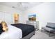 Well-appointed bedroom with television, dresser, and accent chair for relaxing at 780 Drop Shot Dr, Davenport, FL 33896