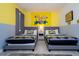 Minion themed bedroom features two twin beds, cartoon wall art, and tile floor at 780 Drop Shot Dr, Davenport, FL 33896