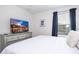Comfortable bedroom features a television and a dresser with drawers for ample storage at 780 Drop Shot Dr, Davenport, FL 33896