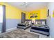 Minion themed bedroom features two twin beds, cartoon wall art, and a ceiling fan at 780 Drop Shot Dr, Davenport, FL 33896