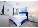 Beautiful bedroom with a large window offering plenty of natural light, a blue headboard and nice decorations at 780 Drop Shot Dr, Davenport, FL 33896