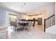 Open-concept dining area features a modern light fixture and access to the pool at 780 Drop Shot Dr, Davenport, FL 33896