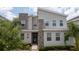 Stylish two-story home with a stone accent wall and modern design elements, showcasing curb appeal at 780 Drop Shot Dr, Davenport, FL 33896