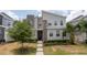 Contemporary two-story home featuring a stone facade, well-manicured lawn, and modern architectural details at 780 Drop Shot Dr, Davenport, FL 33896