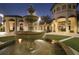 Stunning water fountain feature creates a grand entrance and peaceful ambiance at night at 780 Drop Shot Dr, Davenport, FL 33896