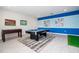 Entertaining game room with pool table and foosball table, great for recreation at 780 Drop Shot Dr, Davenport, FL 33896