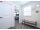 Hallway with bench seating, doorway, and views of the bedroom with a queen bed at 780 Drop Shot Dr, Davenport, FL 33896