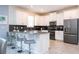 Spacious kitchen with stainless steel appliances and a breakfast bar at 780 Drop Shot Dr, Davenport, FL 33896