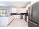 Kitchen with stainless steel appliances, white cabinetry, and gray counters at 780 Drop Shot Dr, Davenport, FL 33896