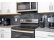 Close-up of a modern kitchen appliance and dark subway tile at 780 Drop Shot Dr, Davenport, FL 33896