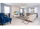Inviting living room with modern furniture, decorative wall panel, and plenty of natural light at 780 Drop Shot Dr, Davenport, FL 33896