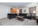 Living room features a sectional sofa, projector, and a warm neutral color palette at 780 Drop Shot Dr, Davenport, FL 33896