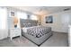 Spacious bedroom with a gray platform bed, patterned bedding, side tables with lamps, and modern decor at 780 Drop Shot Dr, Davenport, FL 33896
