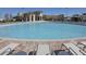 Large community pool offers a refreshing escape with ample lounge seating and sunny skies at 780 Drop Shot Dr, Davenport, FL 33896