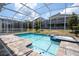 Screened pool with attached spa, surrounded by a brick patio, offering a relaxing outdoor space at 780 Drop Shot Dr, Davenport, FL 33896
