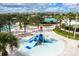 Aerial view of community water park, featuring a splash pad and slides for Gathering fun at 780 Drop Shot Dr, Davenport, FL 33896