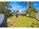Large backyard with a pool screen, lawn, and views of the surrounding greenery at 786 Oxford Dr, Davenport, FL 33897