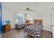 Bedroom featuring two twin beds, hardwood floors, a ceiling fan, and a mounted television at 786 Oxford Dr, Davenport, FL 33897