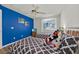 Bedroom with twin beds, wood-look flooring, blue accent wall, and charming Mickey Mouse accents at 786 Oxford Dr, Davenport, FL 33897
