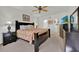 Relaxing bedroom featuring a floral comforter, dark wood furniture, carpet, and a ceiling fan at 786 Oxford Dr, Davenport, FL 33897