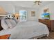 Comfortable bedroom with neutral colors, ceiling fan, and natural light from the window at 786 Oxford Dr, Davenport, FL 33897