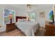 Bright bedroom features wood floors, ceiling fan, and a comfortable bed with side tables at 786 Oxford Dr, Davenport, FL 33897