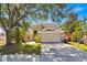 Charming two-story home with a well-maintained lawn and a spacious two-car garage at 786 Oxford Dr, Davenport, FL 33897