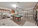 Spacious garage with a pool table, bicycles, and ample space for parking and storage at 786 Oxford Dr, Davenport, FL 33897