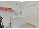 Functional laundry area featuring a washer, dryer, shelving, and neatly organized towels at 786 Oxford Dr, Davenport, FL 33897