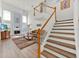 Bright living room featuring hardwood floors, a fireplace, and a staircase at 786 Oxford Dr, Davenport, FL 33897