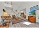 Bright living room featuring hardwood floors, a TV, and a staircase at 786 Oxford Dr, Davenport, FL 33897