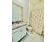 Functional bathroom featuring granite countertops, a single sink, and a shower-tub combo at 7871 Penrose Pl, Wildwood, FL 34785