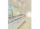 Elegant bathroom featuring granite countertops, double sinks, and a tiled shower at 7871 Penrose Pl, Wildwood, FL 34785