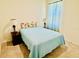 Comfortable bedroom with carpet flooring, soft lighting, and a relaxing atmosphere at 7871 Penrose Pl, Wildwood, FL 34785