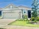 Charming single-Gathering home with a well-maintained lawn, stone accents, and a two-car garage at 7871 Penrose Pl, Wildwood, FL 34785