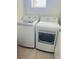 Bright laundry room featuring a modern washer and dryer set for convenient chores at 7871 Penrose Pl, Wildwood, FL 34785