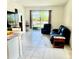 Comfortable living room area featuring tile flooring, a sliding glass door and a view to the patio at 7871 Penrose Pl, Wildwood, FL 34785