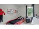 Fun, race car themed bedroom featuring a car bed, framed pictures, and tire accents at 801 Ambleside Dr, Haines City, FL 33844