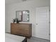 Bedroom featuring stylish dresser with decorative mirrors and a neutral color scheme for a modern look at 801 Ambleside Dr, Haines City, FL 33844