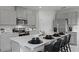 Modern kitchen with stainless steel appliances, gray cabinets, and a spacious island with seating at 801 Ambleside Dr, Haines City, FL 33844