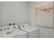 Laundry area featuring a modern washer and dryer with decorative artwork at 801 Ambleside Dr, Haines City, FL 33844