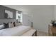 A relaxing bedroom with a gray accent wall, decorative pillows, and an en-suite bathroom for added convenience at 801 Ambleside Dr, Haines City, FL 33844