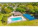 Aerial view of the community pool and basketball court with covered seating area and surrounding green space at 807 Ayden Oak Ln, Ocoee, FL 34761