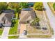 An aerial view of a single story home featuring a brick driveway, two palm trees and an attached two-car garage at 807 Ayden Oak Ln, Ocoee, FL 34761