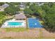 Aerial view of a basketball court, pool, and clubhouse surrounded by lush trees in a quiet neighborhood at 807 Ayden Oak Ln, Ocoee, FL 34761